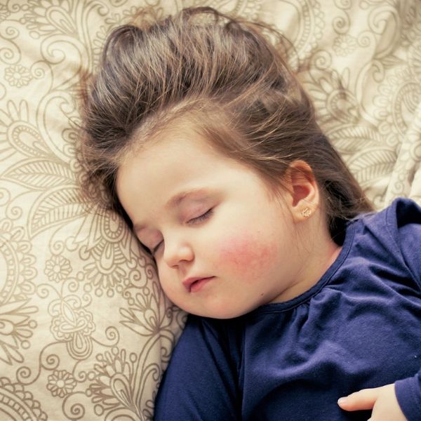 Krankes Baby liegt im Bett und schläft